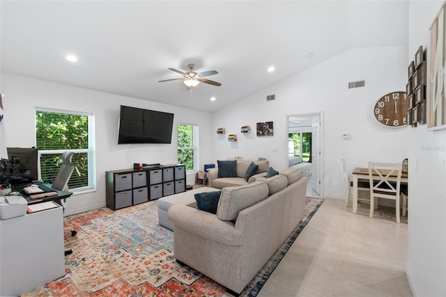 living room featuring a healthy amount of sunlight, ceiling fan, light tile patterned floors, and vaulted ceiling