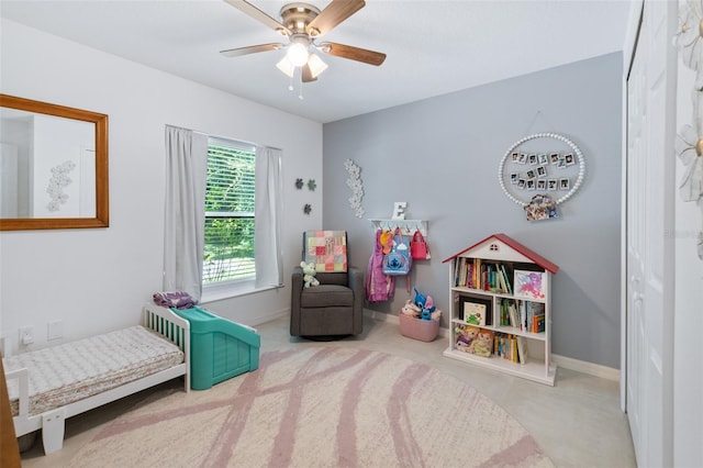 playroom with carpet flooring, a ceiling fan, and baseboards