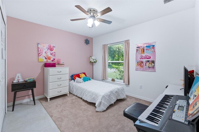 bedroom featuring ceiling fan, light carpet, visible vents, and baseboards