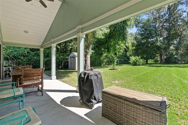 view of patio / terrace with a storage shed, an outdoor structure, a grill, and a ceiling fan