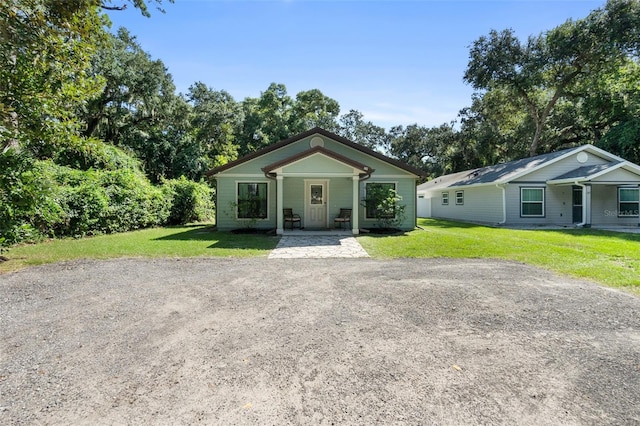 view of front facade with a front yard and driveway