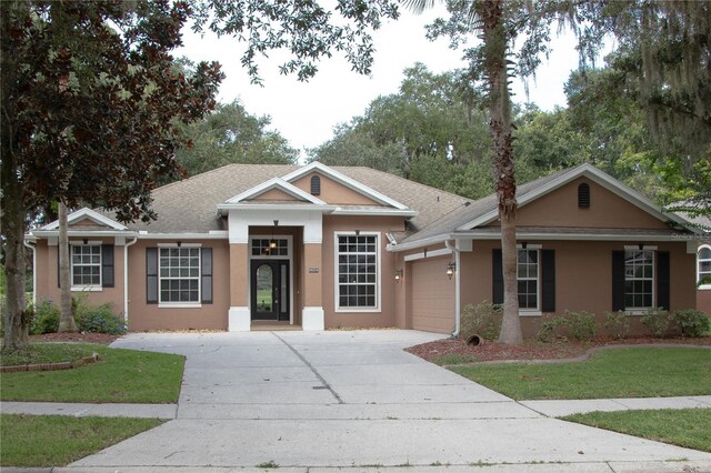 view of front facade with a front yard and a garage