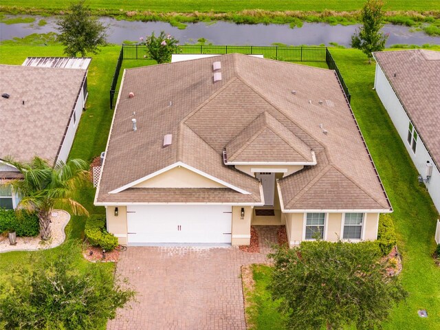 birds eye view of property with a water view