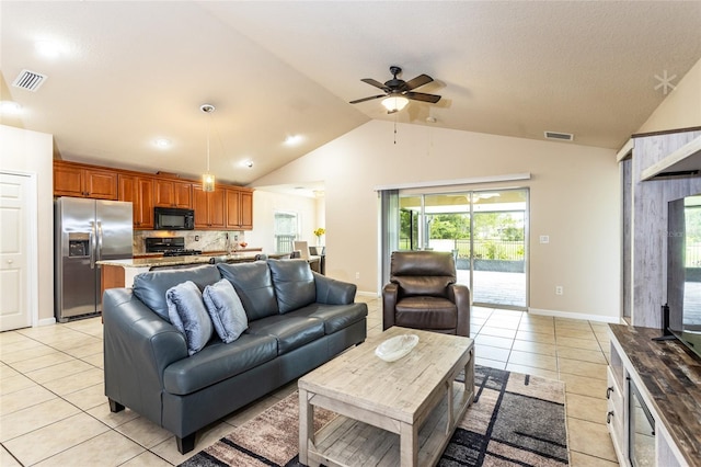 tiled living room with ceiling fan and vaulted ceiling