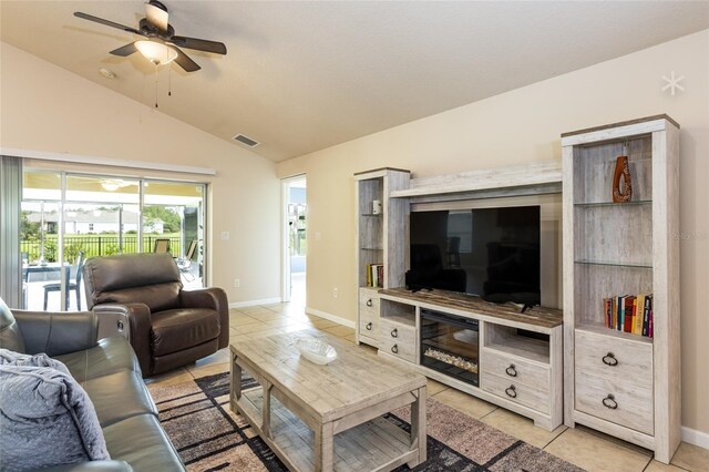 living room with lofted ceiling, light tile patterned floors, and ceiling fan