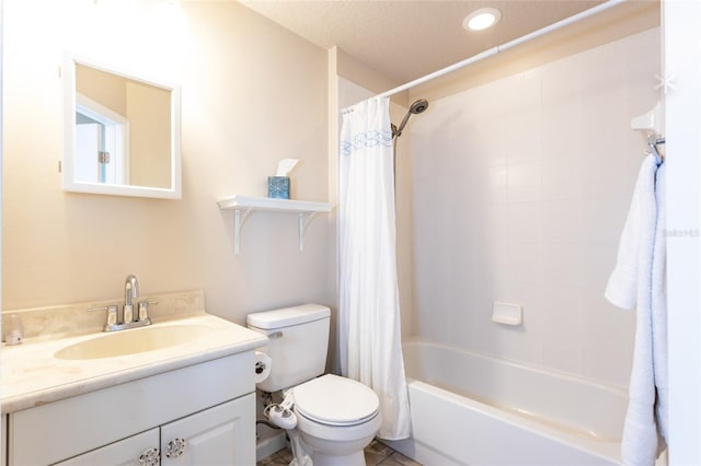 full bathroom featuring tile patterned floors, toilet, vanity, shower / bath combo with shower curtain, and a textured ceiling