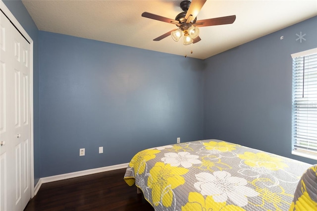 bedroom featuring ceiling fan, hardwood / wood-style floors, and a closet