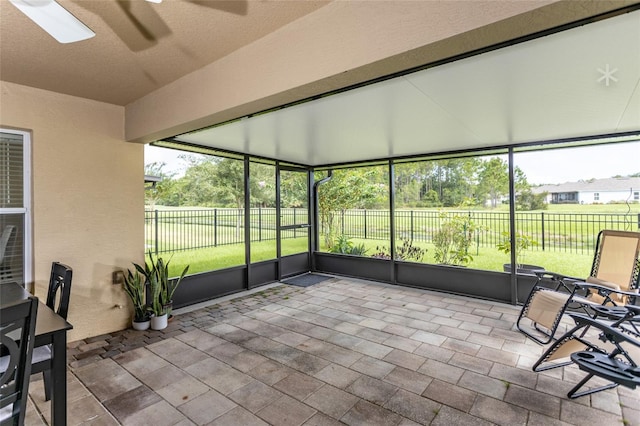 unfurnished sunroom featuring a skylight and ceiling fan