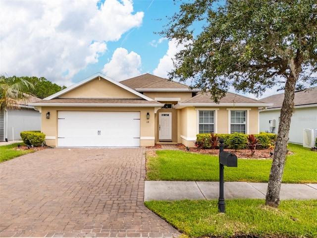 118 Golfview Ct, Bunnell, FL 32110 - ranch-style home with stucco siding, decorative driveway, a garage, a front yard, and roof with shingles