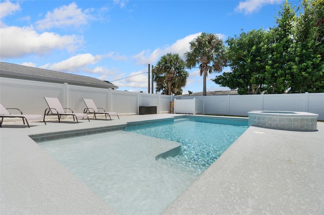 view of swimming pool with a patio area and an in ground hot tub