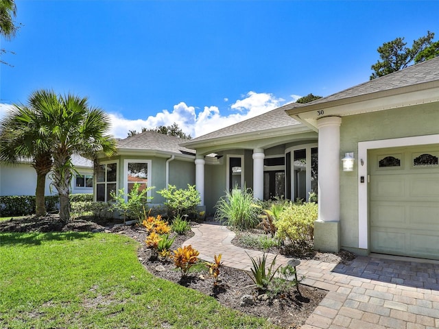 view of front of house with a garage and a front lawn