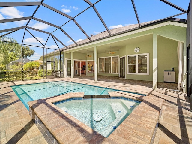 view of pool with a lanai, a patio, ceiling fan, and an in ground hot tub