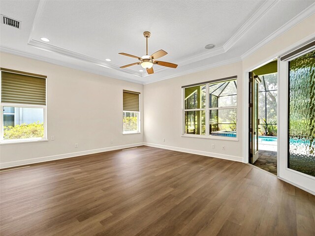 unfurnished room with a textured ceiling, ceiling fan, dark hardwood / wood-style floors, and ornamental molding