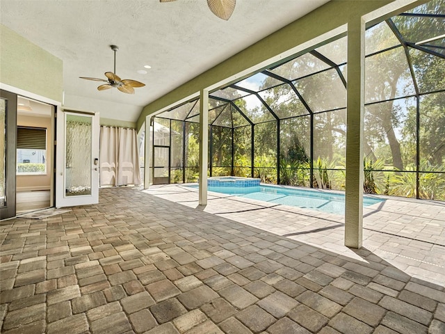 view of swimming pool with ceiling fan, a patio, and a lanai