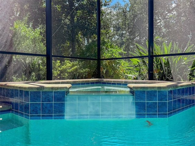 view of swimming pool with a lanai