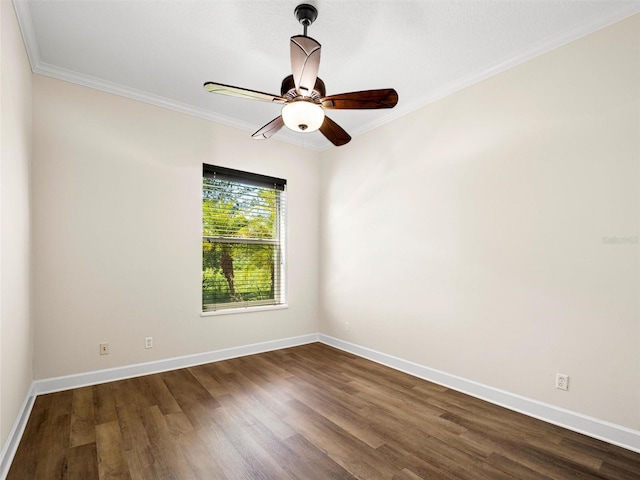 spare room with ornamental molding, dark wood-type flooring, and ceiling fan