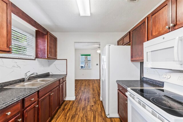 kitchen featuring backsplash, white appliances, dark hardwood / wood-style flooring, sink, and ceiling fan