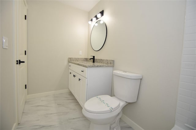 bathroom featuring toilet, marble finish floor, baseboards, and vanity