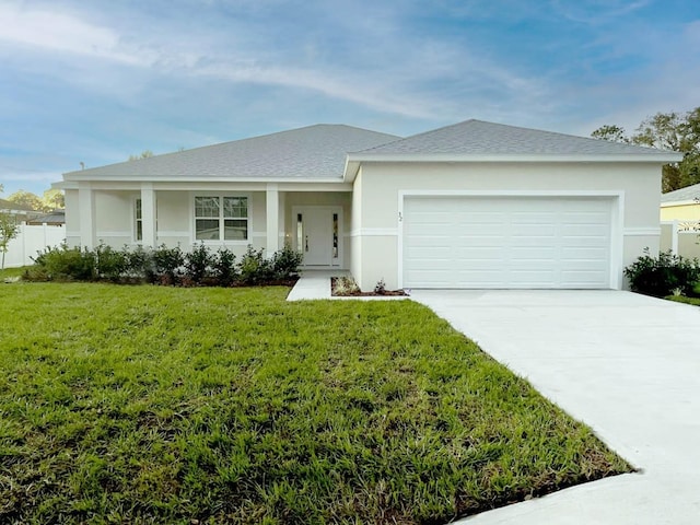 ranch-style house featuring stucco siding, an attached garage, driveway, and a front yard