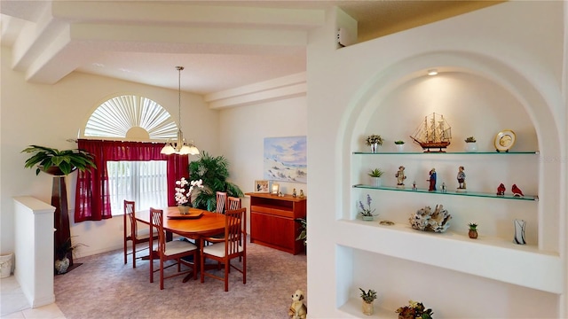 carpeted dining space featuring beamed ceiling