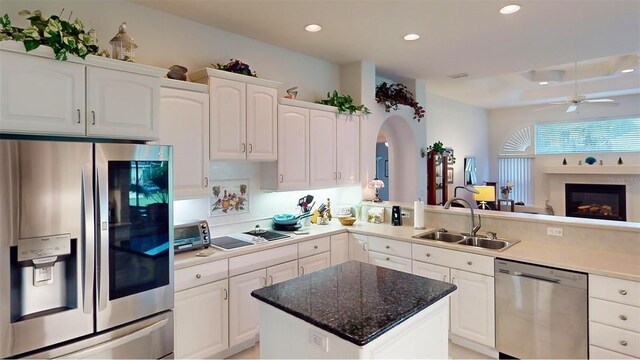 kitchen with appliances with stainless steel finishes, white cabinetry, and sink