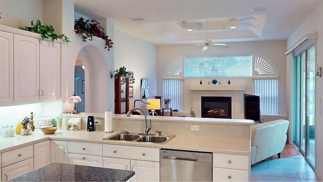 kitchen featuring dishwasher, white cabinetry, plenty of natural light, and sink