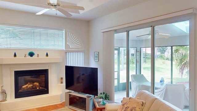 living room featuring plenty of natural light, ceiling fan, and hardwood / wood-style flooring