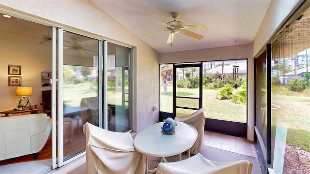 sunroom with lofted ceiling and ceiling fan