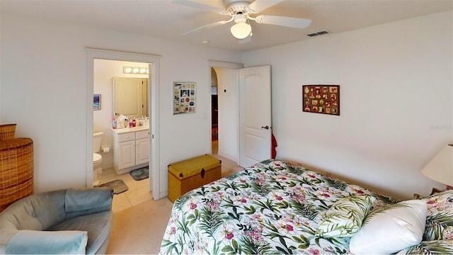 bedroom with light tile patterned flooring, connected bathroom, and ceiling fan