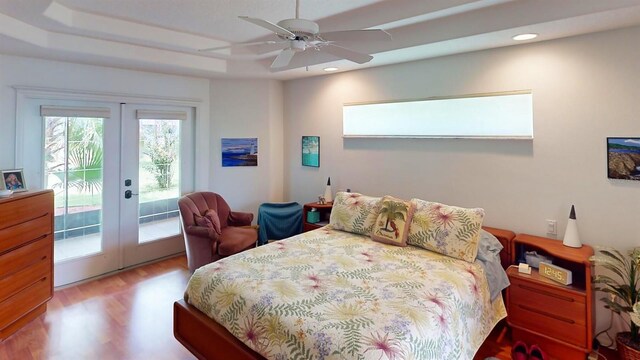 bedroom featuring ceiling fan, hardwood / wood-style floors, french doors, and access to outside