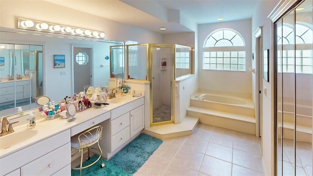 bathroom with tile patterned flooring, vanity, and shower with separate bathtub