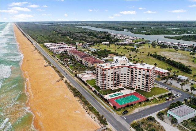 birds eye view of property featuring a beach view and a water view