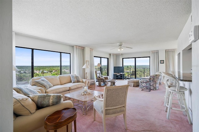 living room featuring ceiling fan, carpet floors, a wall mounted air conditioner, and a textured ceiling