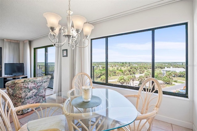 dining area with a wealth of natural light, an inviting chandelier, and light tile patterned flooring