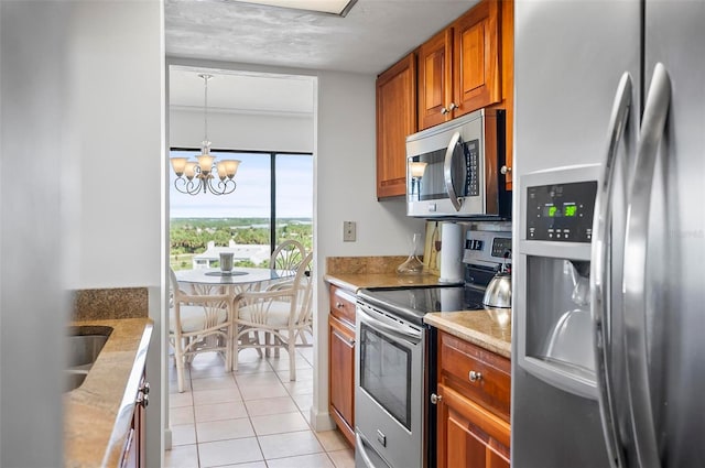 kitchen with light tile patterned floors, an inviting chandelier, decorative light fixtures, stainless steel appliances, and a textured ceiling