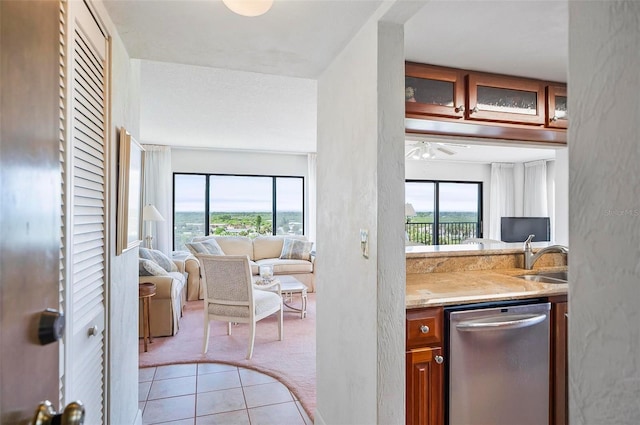 kitchen with dishwasher, ceiling fan, sink, and light carpet