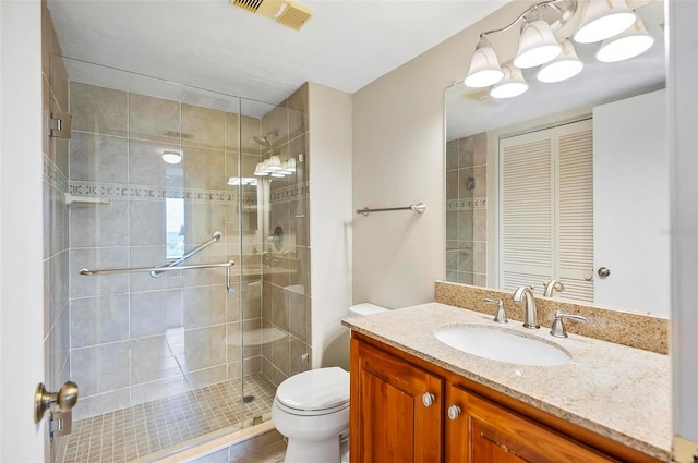 bathroom featuring walk in shower, toilet, and vanity