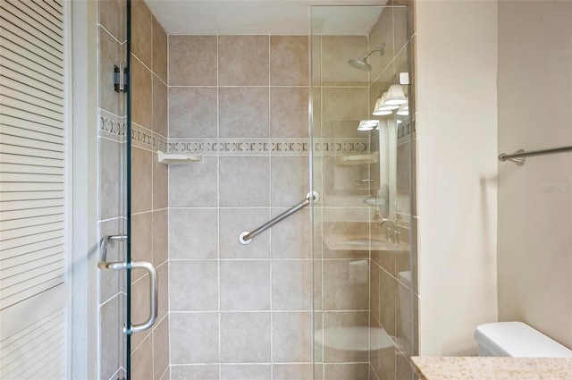 bathroom with toilet and an enclosed shower