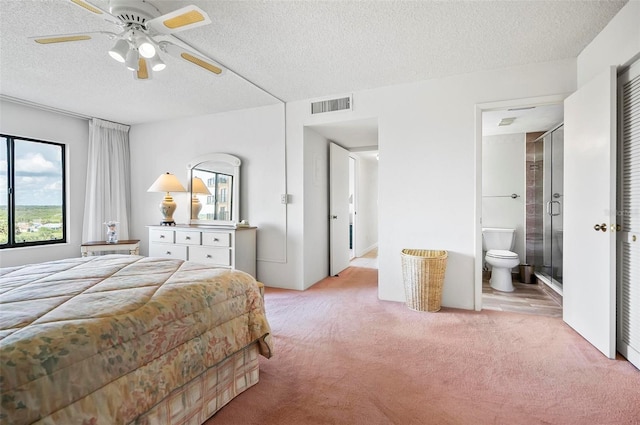 carpeted bedroom featuring multiple windows, ceiling fan, and a textured ceiling