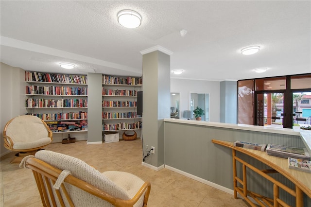 sitting room with a textured ceiling and light tile patterned flooring