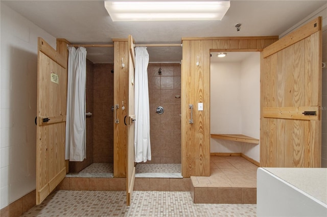 bathroom with a shower with shower curtain and tile patterned floors