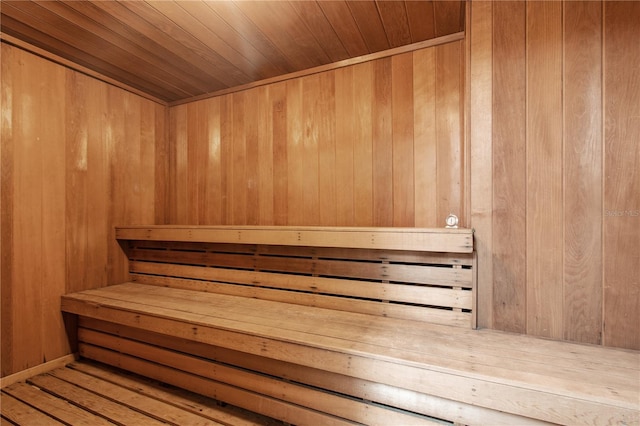 view of sauna / steam room featuring wood walls, hardwood / wood-style floors, and wooden ceiling