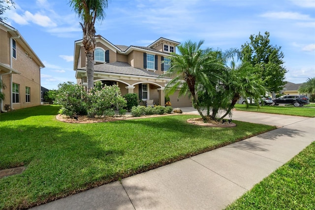 view of front facade with a shingled roof, concrete driveway, a front yard, stucco siding, and a garage