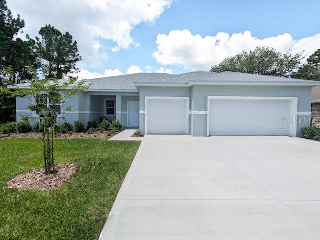 view of front of property with a garage and a front lawn