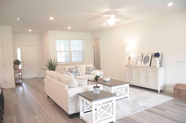 living room with light wood-type flooring and ceiling fan