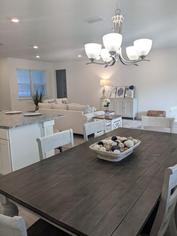 dining room featuring an inviting chandelier and dark hardwood / wood-style flooring