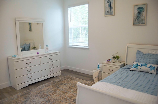 bedroom with dark hardwood / wood-style flooring