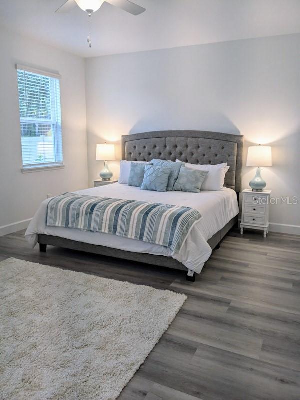 bedroom featuring ceiling fan and dark hardwood / wood-style flooring