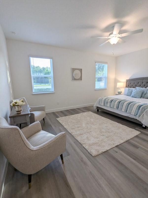 bedroom with ceiling fan and hardwood / wood-style floors