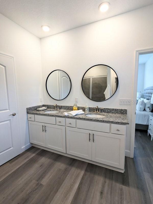 bathroom featuring vanity and hardwood / wood-style floors